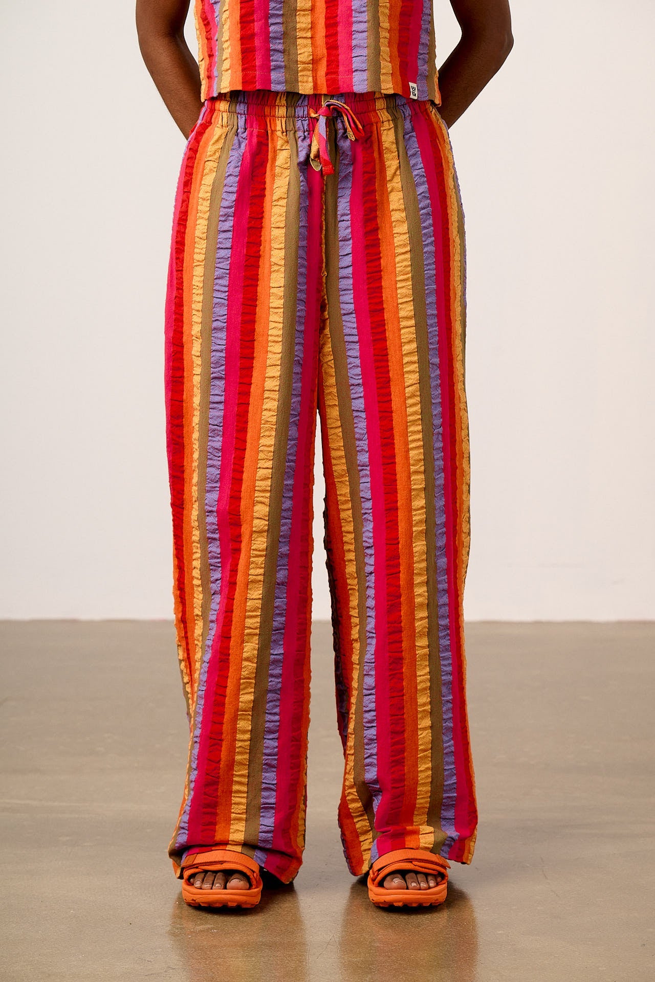 Norris - Wide Leg Cotton Trousers in Wide Rainbow Stripe