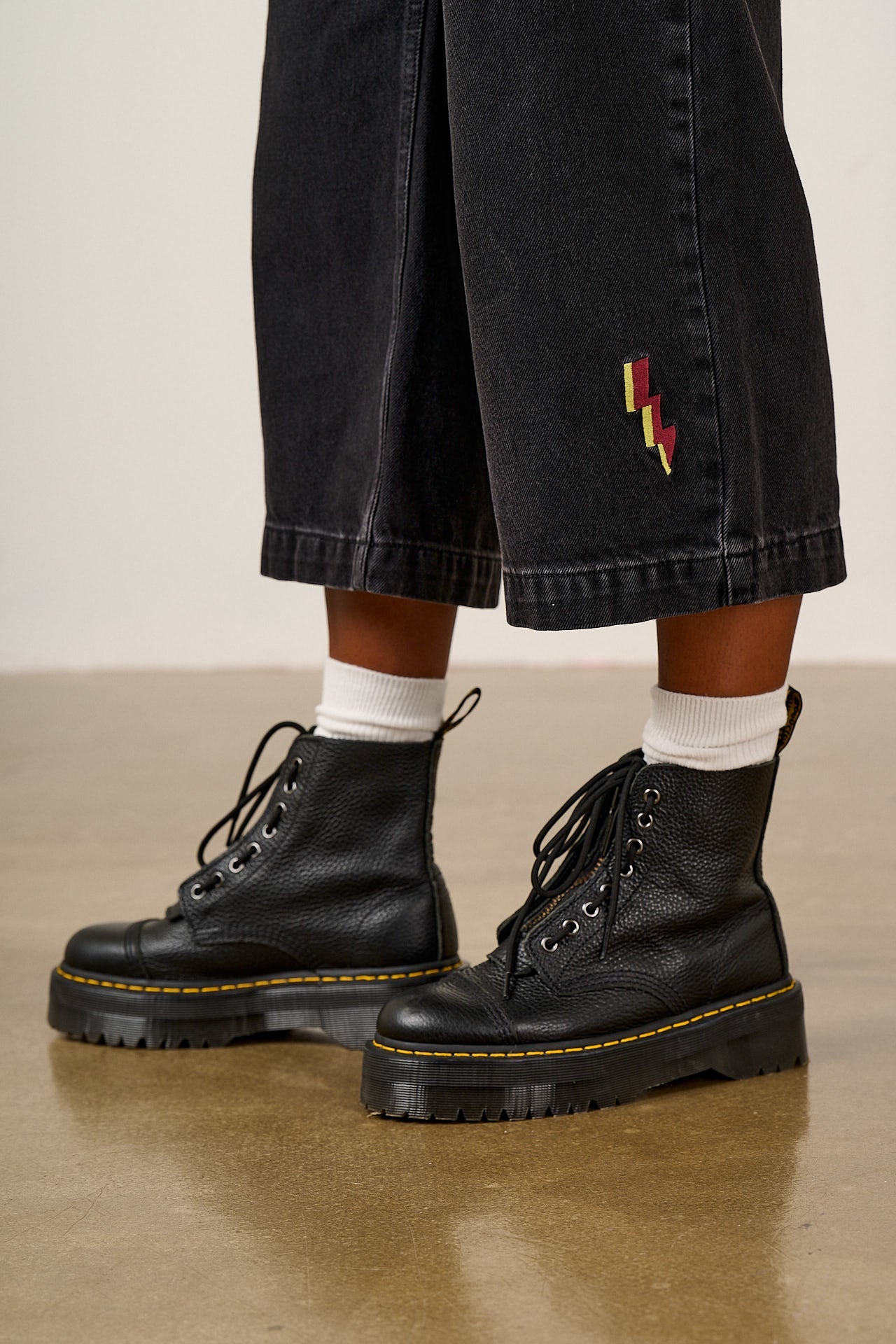Ragan - Denim Jumpsuit in Washed Black with Punk Energy Patches